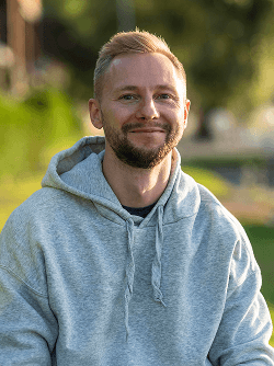 Elore team member in grey hoodie outdoors